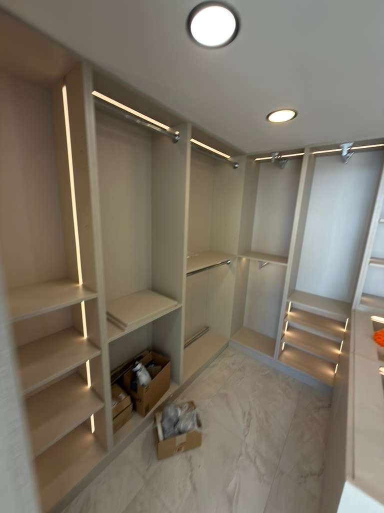 Custom walk-in closet with LED lighting and built-in shelving