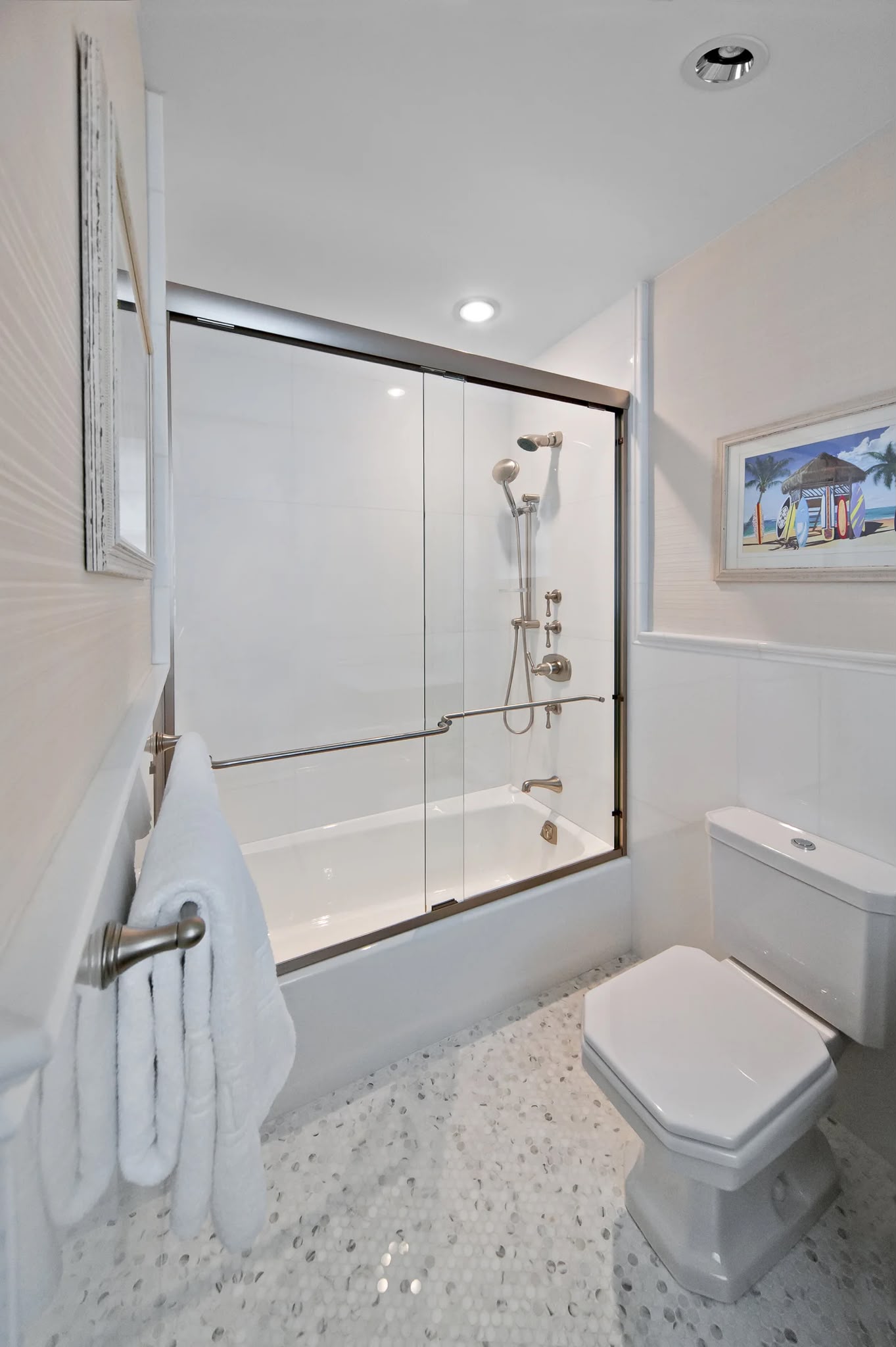 Sliding glass tub enclosure with brushed nickel hardware