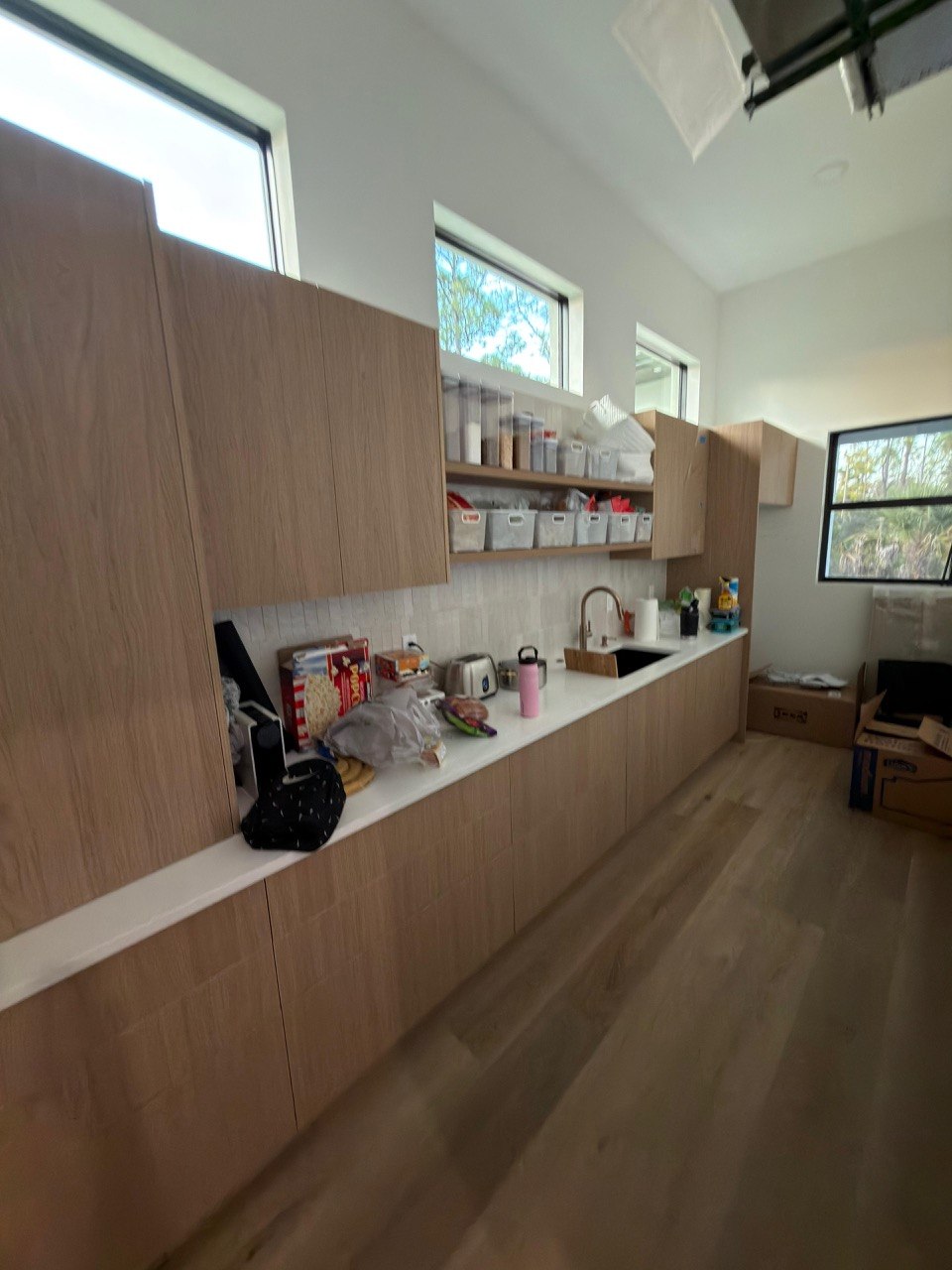 Contemporary kitchen with natural wood cabinets and open shelving