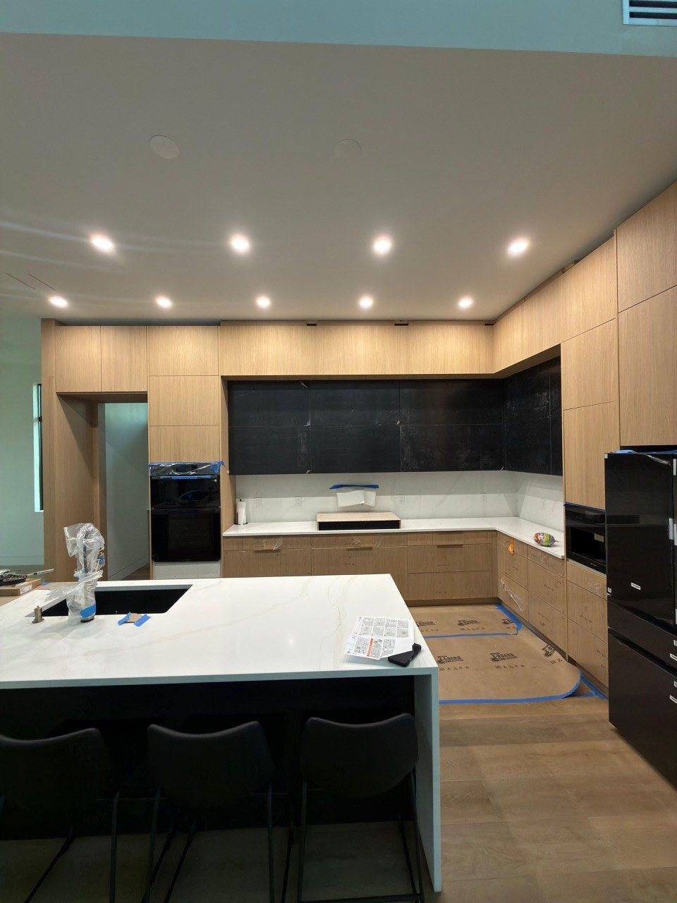 Premium kitchen with quartz island and wood cabinetry